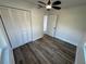 Bedroom with modern wood-look floors and a large closet for ample storage, with plenty of natural light at 1289 E Hancock Dr, Deltona, FL 32725