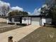 Charming single-story home features a one-car garage and a long driveway at 1289 E Hancock Dr, Deltona, FL 32725