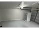 Spacious garage with painted walls and floors, offering ample room for parking and storage at 1289 E Hancock Dr, Deltona, FL 32725