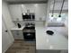 Modern kitchen with stainless steel appliances, sleek countertops, and contemporary lighting fixtures at 1289 E Hancock Dr, Deltona, FL 32725