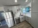 Bright kitchen with stainless steel appliances, quartz countertops, and ample storage space at 1289 E Hancock Dr, Deltona, FL 32725