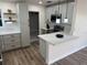 Modern kitchen with stainless steel appliances, updated cabinets, and stylish pendant lighting at 1289 E Hancock Dr, Deltona, FL 32725