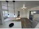 Open-concept living area with modern lighting, new vinyl floors, and access to the kitchen at 1289 E Hancock Dr, Deltona, FL 32725