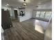 Open-concept living space with new vinyl floors and access to the kitchen and exterior at 1289 E Hancock Dr, Deltona, FL 32725