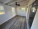 Cozy sunroom featuring a ceiling fan, new vinyl floors, and a door leading to the outside at 1289 E Hancock Dr, Deltona, FL 32725