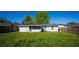 Spacious backyard with lush green grass, wood fence, and a cozy exterior view of the home at 1315 Overdale St, Orlando, FL 32825