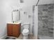 Bathroom featuring a shower with marble tiling, complemented by nautical wall art and a classic vanity at 1315 Overdale St, Orlando, FL 32825