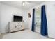 Cozy bedroom featuring tiled floors, a TV with a cabinet, and bright natural light at 1315 Overdale St, Orlando, FL 32825