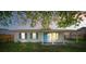 Charming single-story home featuring a cozy front porch and vibrant blue door and shutters at 1315 Overdale St, Orlando, FL 32825