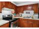 Practical kitchen featuring wood cabinetry and a stainless steel oven at 1315 Overdale St, Orlando, FL 32825