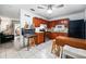 Functional kitchen featuring wood cabinets, tile floors, and stainless steel appliances at 1315 Overdale St, Orlando, FL 32825