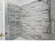 Elegant shower with gray tiling, a shower head and door with brass fixtures at 1315 Overdale St, Orlando, FL 32825