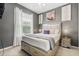 Stylish bedroom featuring a comfortable bed with decorative pillows and matching nightstands at 14318 Fieldstone Lake Way, Orlando, FL 32824
