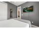 Cozy bedroom featuring a TV, mirror and closet for plenty of storage space at 14318 Fieldstone Lake Way, Orlando, FL 32824