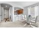 Cozy dining area with a glass table, modern chairs, and open archway to the kitchen at 14318 Fieldstone Lake Way, Orlando, FL 32824