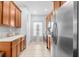 Bright kitchen featuring wood cabinets, stainless steel appliances, and tile flooring at 14318 Fieldstone Lake Way, Orlando, FL 32824