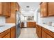 Spacious kitchen with wood cabinets, stainless steel appliances, and tile flooring at 14318 Fieldstone Lake Way, Orlando, FL 32824