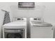 Convenient laundry room features modern appliances, overhead rack, and practical layout for easy chores at 14318 Fieldstone Lake Way, Orlando, FL 32824