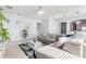 Open living space with a large sofa, modern decor, and plenty of natural light at 14318 Fieldstone Lake Way, Orlando, FL 32824