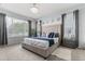 Spacious main bedroom with large windows, stylish decor, and a comfortable king-size bed at 14318 Fieldstone Lake Way, Orlando, FL 32824