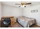 A bedroom features a bed, desk, chair, ceiling fan, and a mount for a television at 1575 Eucalyptus Way, Davenport, FL 33837