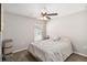 A bright bedroom features a ceiling fan, one window with blinds, carpet, and a simple decor at 1575 Eucalyptus Way, Davenport, FL 33837