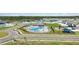 Aerial view of community pool and playground featuring a cabana and ample seating at 1575 Eucalyptus Way, Davenport, FL 33837