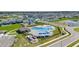 Community pool with seating and cabana in a neighborhood with green lawns at 1575 Eucalyptus Way, Davenport, FL 33837