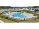 Community swimming pool area featuring palm trees, chairs and covered seating at 1575 Eucalyptus Way, Davenport, FL 33837