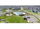 Aerial view of neighborhood pool, playground, parking, and cabana at 1575 Eucalyptus Way, Davenport, FL 33837