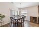 Cozy dining room featuring a wood table with six chairs, chandelier, and sliding glass door to the outdoor patio at 1575 Eucalyptus Way, Davenport, FL 33837