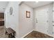 Inviting foyer features wood-look floors, a white front door, and a decorative mirror at 1575 Eucalyptus Way, Davenport, FL 33837