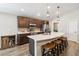 Modern kitchen with a large island, stainless steel appliances, and ample dark wood cabinetry at 1575 Eucalyptus Way, Davenport, FL 33837
