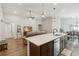 A modern kitchen with an island opens to the living and dining areas, with recessed lighting and wood-look floors at 1575 Eucalyptus Way, Davenport, FL 33837