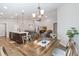 Open-concept living space with kitchen island, dining table, recessed lighting, and two gray sofas around a TV at 1575 Eucalyptus Way, Davenport, FL 33837