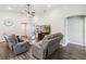 Spacious living room with wood-look floors, vaulted ceilings, and comfortable reclining sofas at 1575 Eucalyptus Way, Davenport, FL 33837