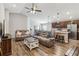 Open-concept living area with wood-look floors flowing into a modern kitchen and dining area at 1575 Eucalyptus Way, Davenport, FL 33837