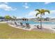 Community pool area featuring palm trees, lounge chairs, and a covered pavilion at 1575 Eucalyptus Way, Davenport, FL 33837