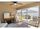 Cozy screened patio featuring modern furniture, a ceiling fan, and a wall-mounted TV at 1575 Eucalyptus Way, Davenport, FL 33837