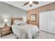 Cozy bedroom with a wicker headboard and soft, neutral color scheme, creating a serene retreat at 174 Yellow Snapdragon Dr, Davenport, FL 33837