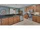 Spacious kitchen featuring granite countertops, stainless steel appliances, and wood cabinetry at 174 Yellow Snapdragon Dr, Davenport, FL 33837
