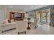 Comfortable living room with a large sliding glass door to the pool area and neutral decor at 174 Yellow Snapdragon Dr, Davenport, FL 33837