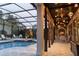 A covered patio with a well lit pool area at 174 Yellow Snapdragon Dr, Davenport, FL 33837