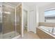 Bright bathroom showcasing a glass-enclosed shower and soaking tub at 1893 Rafton Rd, Apopka, FL 32703
