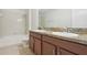 Inviting bathroom with dual sinks and a tub shower combo, perfect for a relaxing and functional space at 1893 Rafton Rd, Apopka, FL 32703