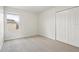Bright bedroom with a window and a closet featuring neutral carpet flooring, ideal for a relaxing retreat at 1893 Rafton Rd, Apopka, FL 32703