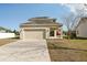 Two story home with a large garage and front yard at 1893 Rafton Rd, Apopka, FL 32703