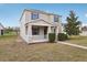 Inviting two-story home featuring a covered porch, muted exterior and well-manicured lawn at 1893 Rafton Rd, Apopka, FL 32703