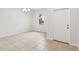Bright living room with tile flooring, a window and white door with chandelier at 1893 Rafton Rd, Apopka, FL 32703