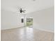 Open living room with neutral tile, sliding glass doors to the yard, and a ceiling fan at 1893 Rafton Rd, Apopka, FL 32703